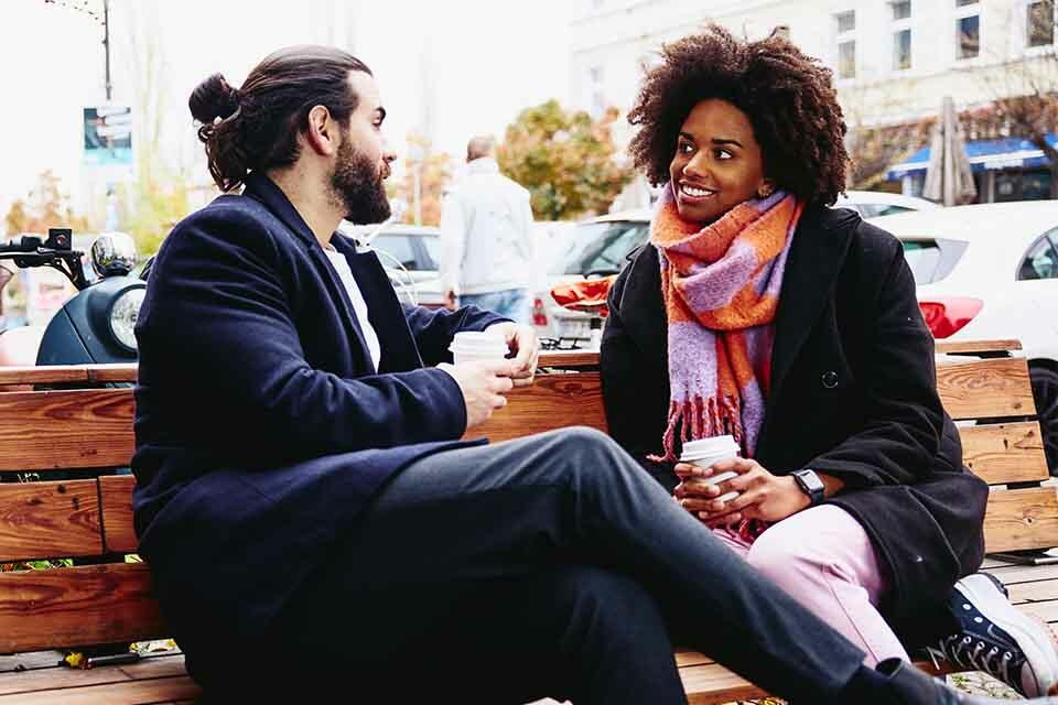 two people talking on a bench