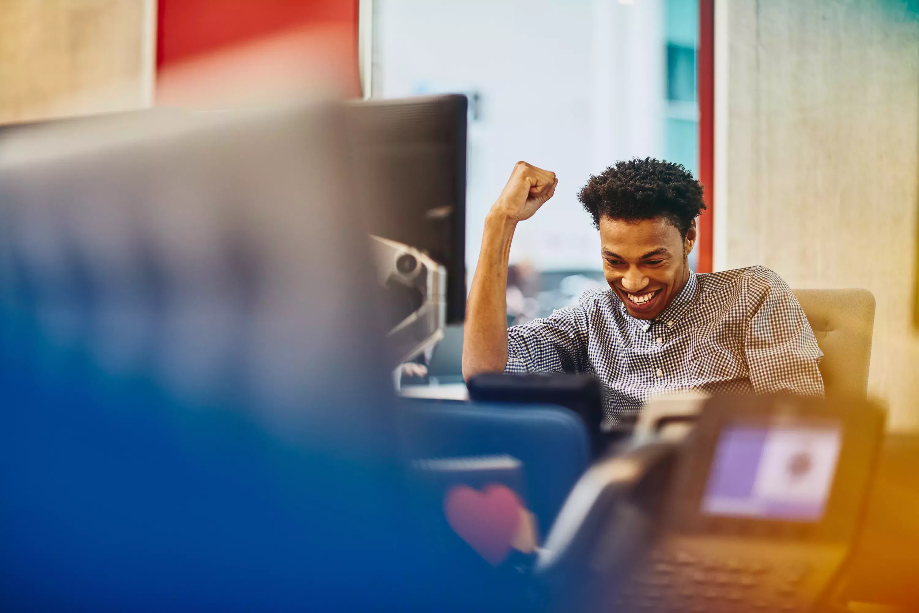 Male cheering at his desk 