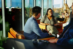 four persons in lounge socializing with each other