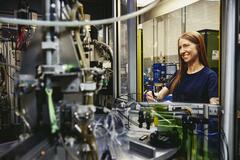 Woman operating a machine on a production site. 